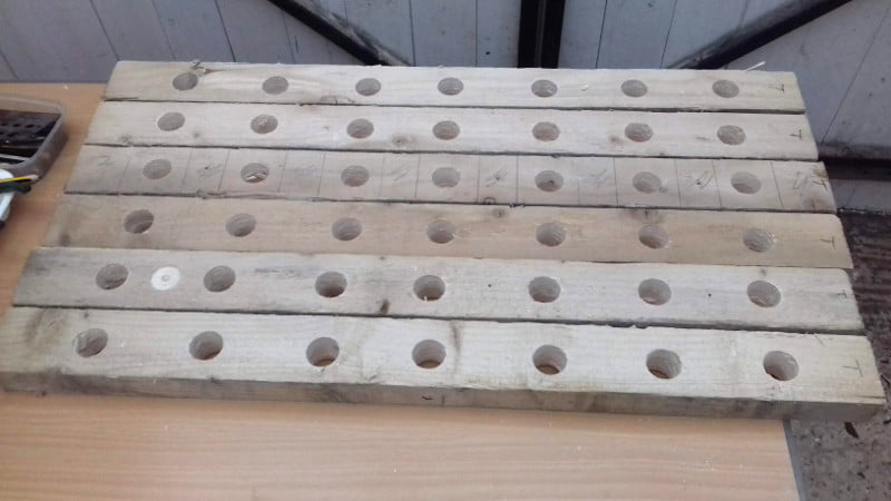 28 peg holes drilled in clamps